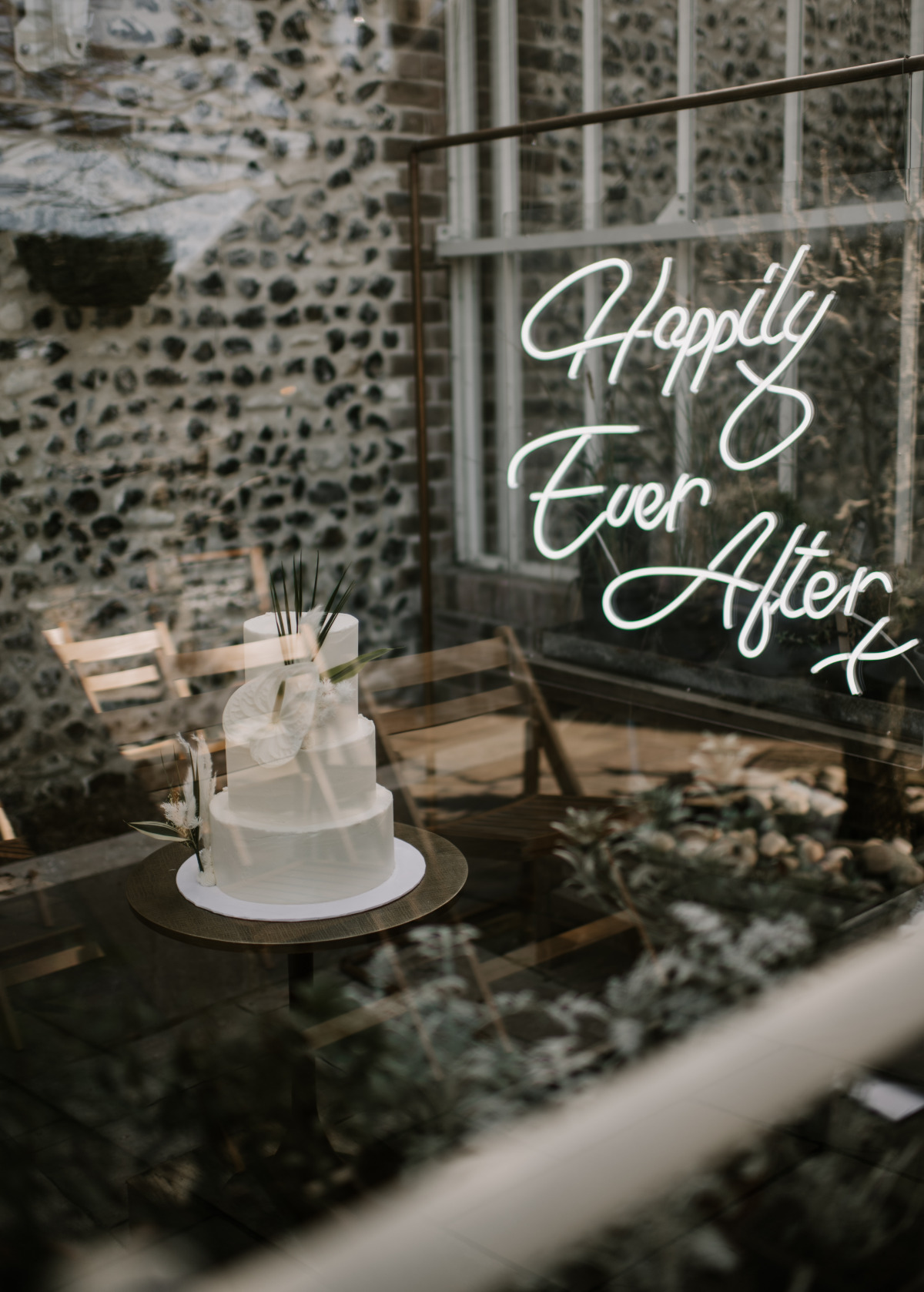 happily ever after neon sign with white wedding cake