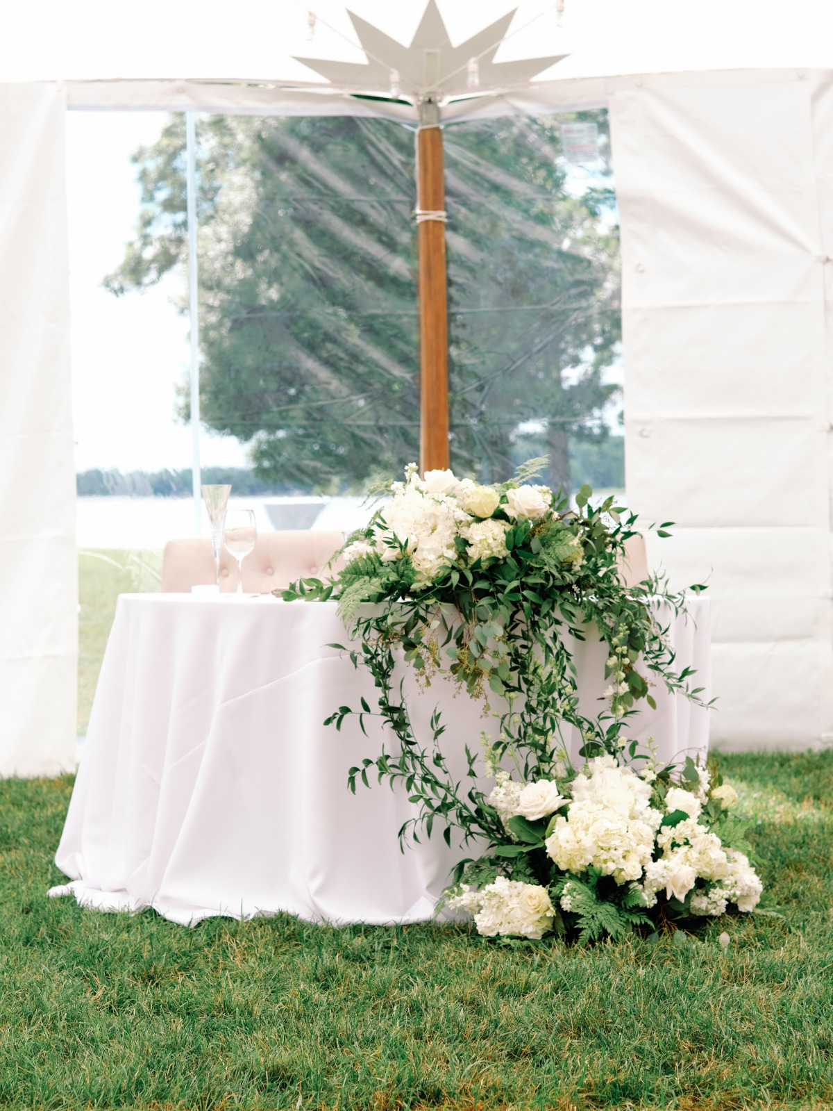 Elegant cascading greenery sweetheart table