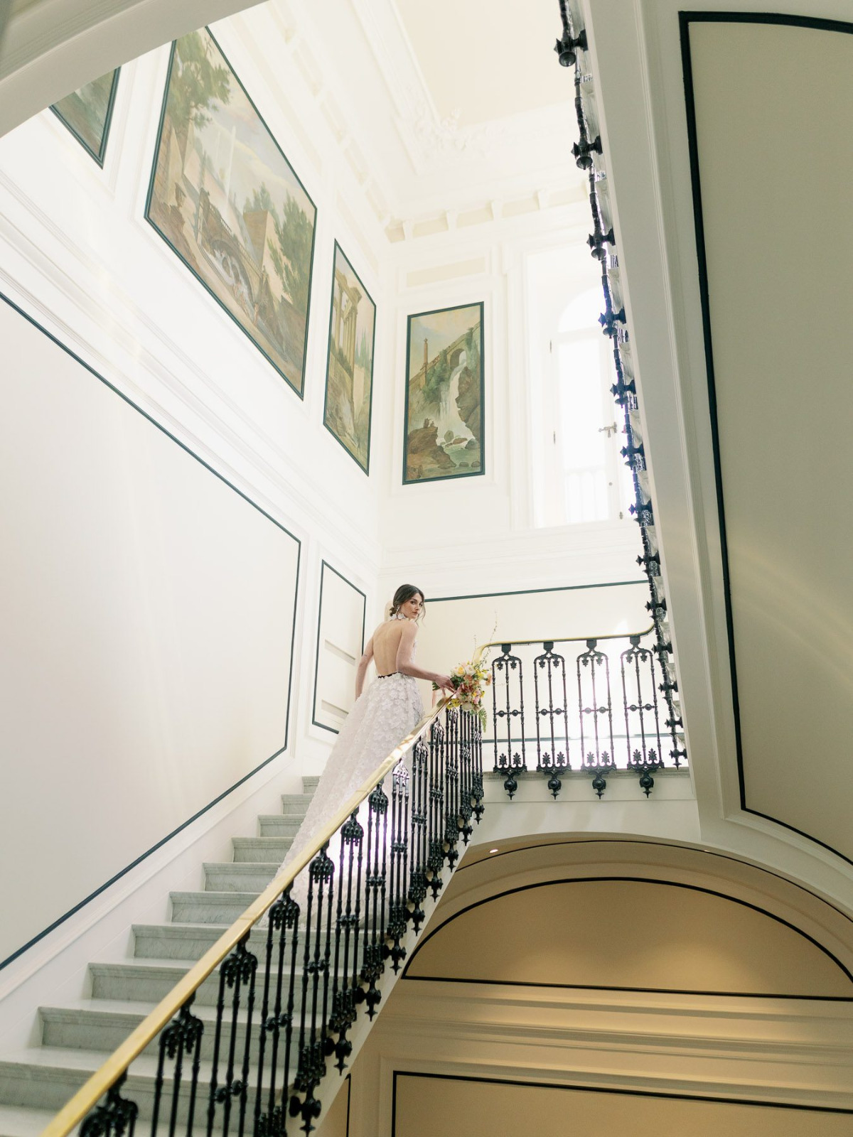 Bride walking up villa stairs