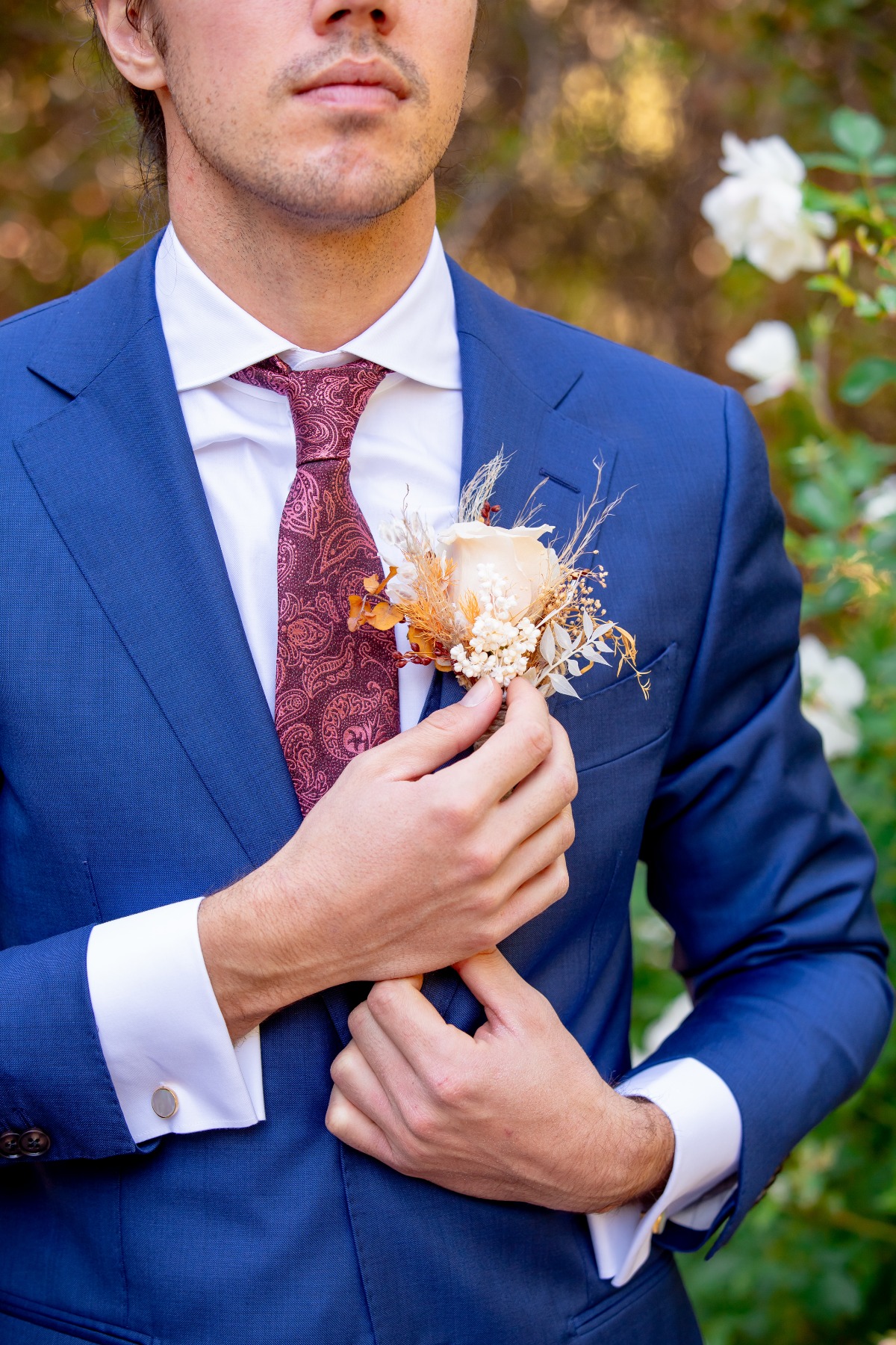 groom in blue suit with dried flower boutonniere