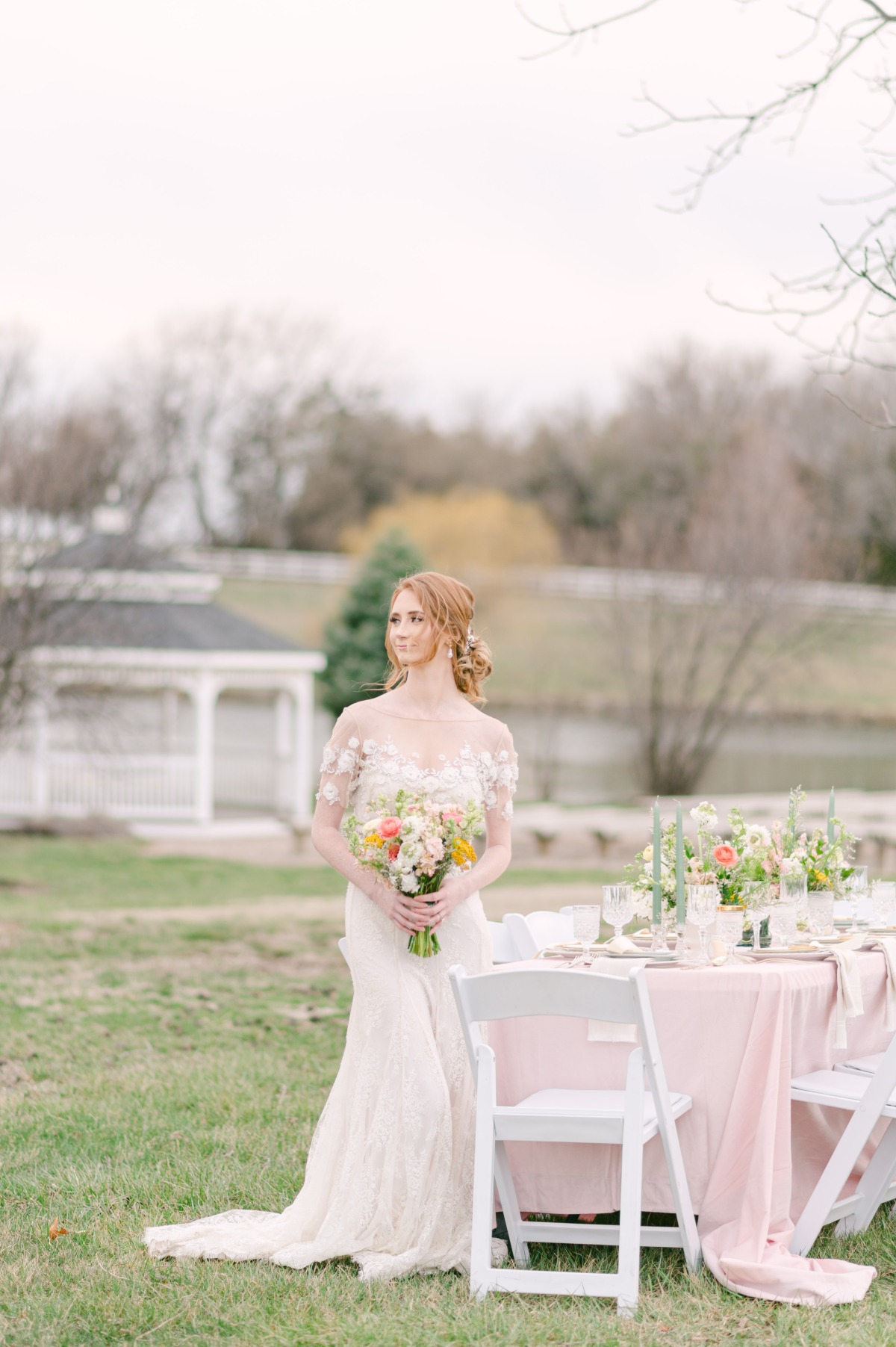 Bride beside elegant wedding table 