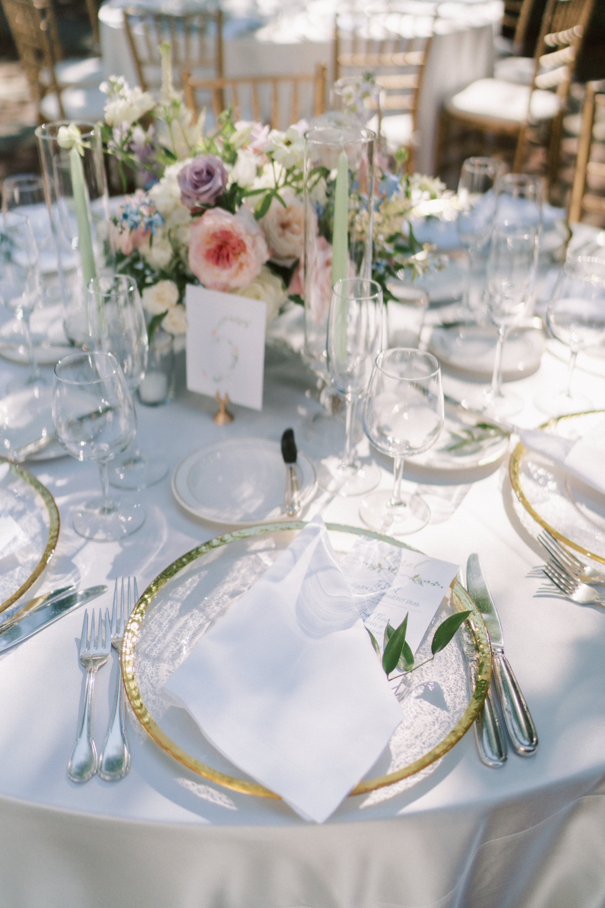 gold rimmed plates at garden party wedding