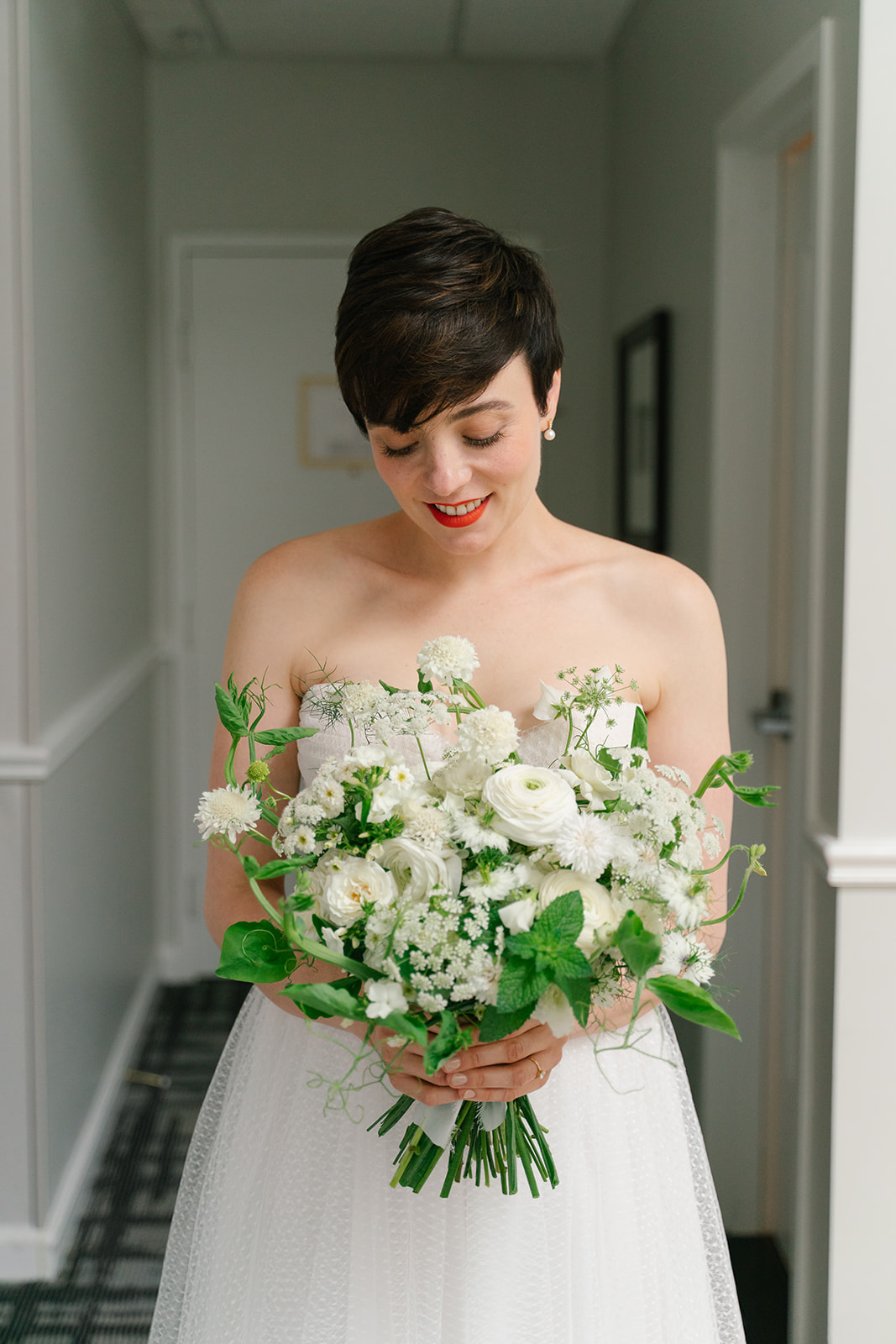 Bride with abundant greenery bouquet