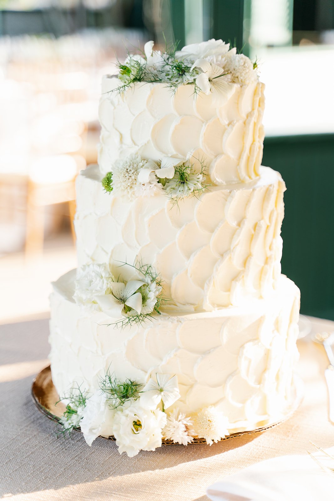 Modern understated wedding cake with florals