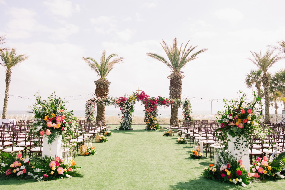 rainbow tropical floral wedding with arch
