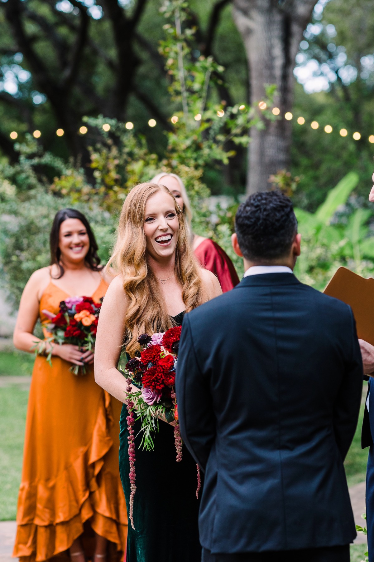 Laughing bride at jewel tone wedding ceremony