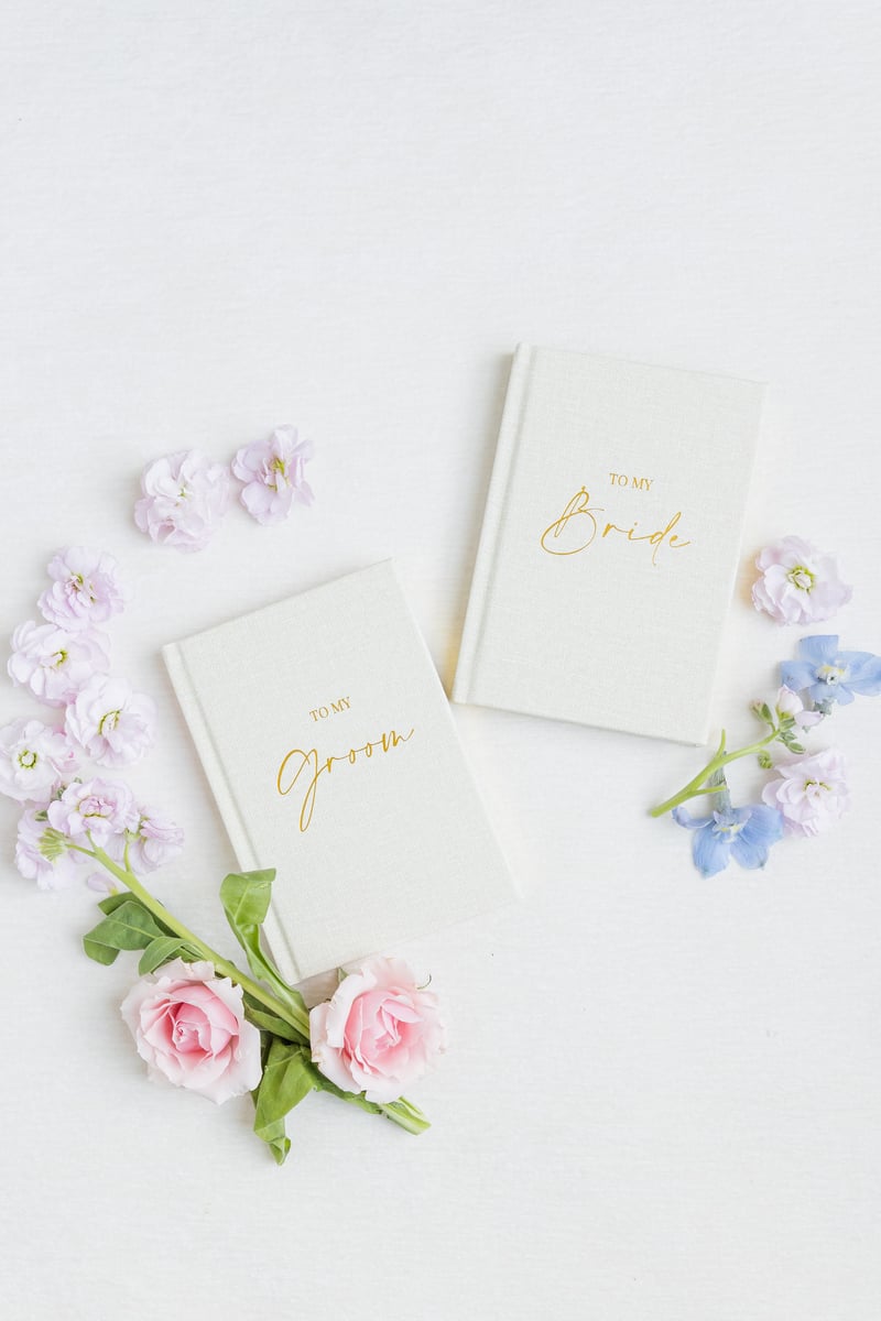 white and gold vow booklets