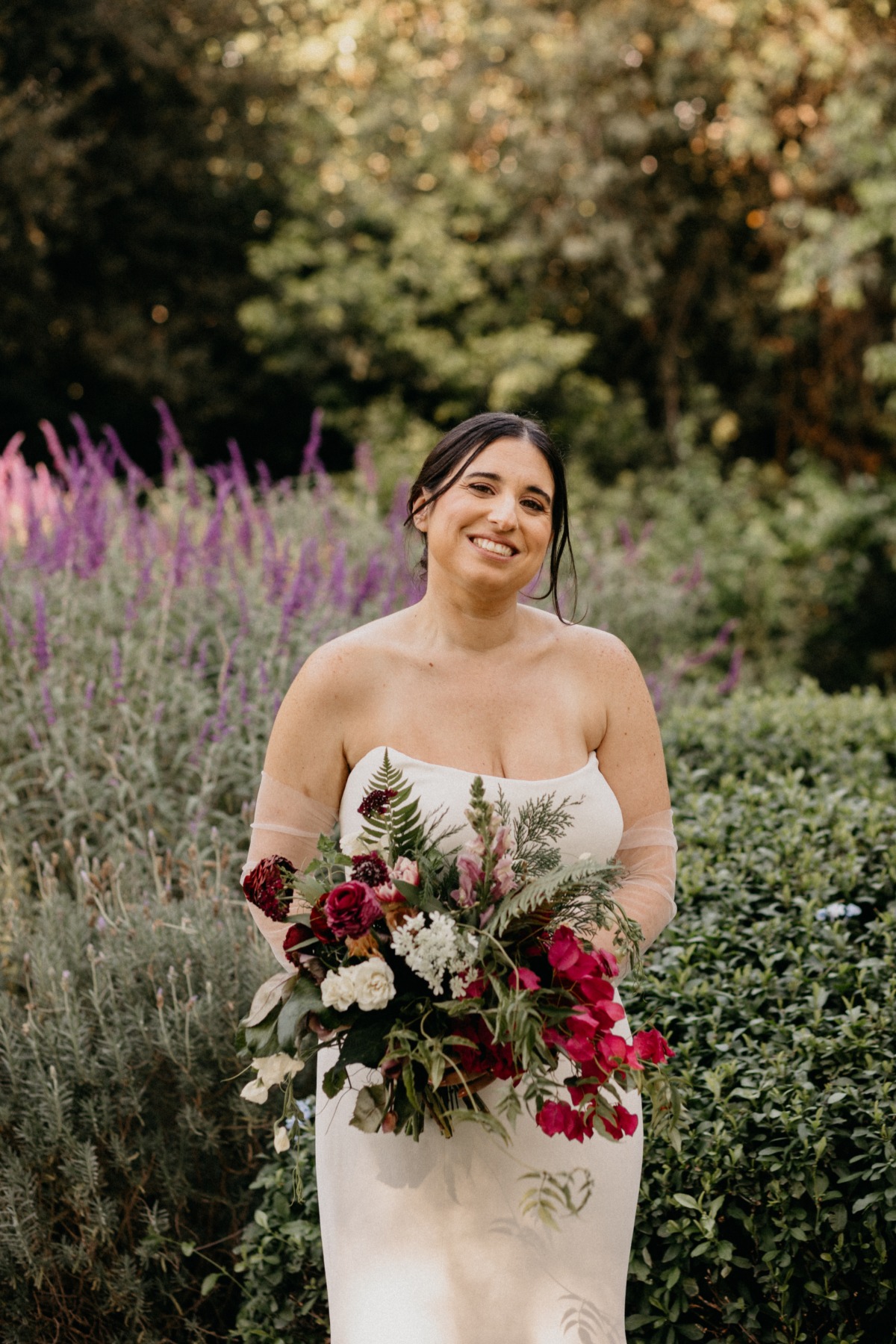 Bride in Vera Wang dress with colorful bouquet 