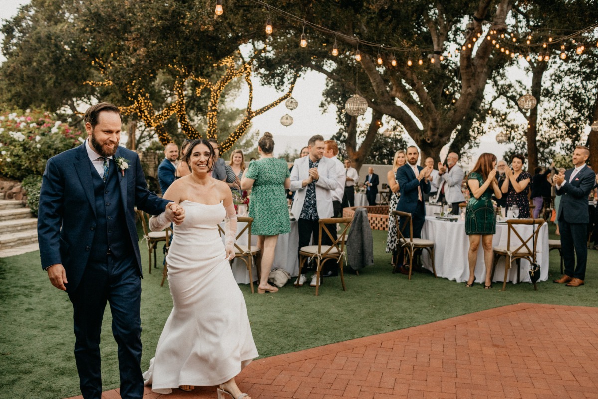 Modern bride and groom enter dance floor 