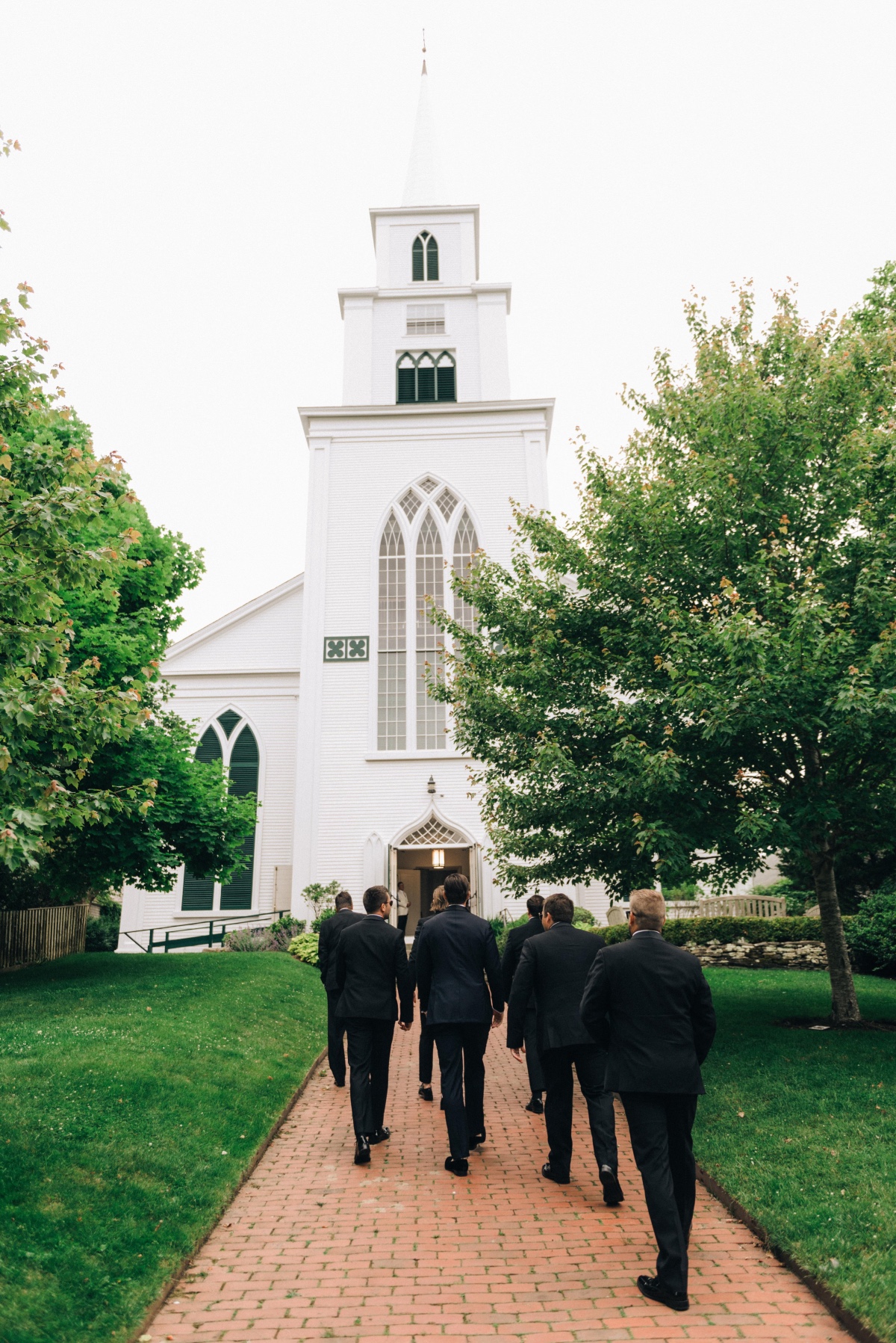 Groomsmen walking to chapel 