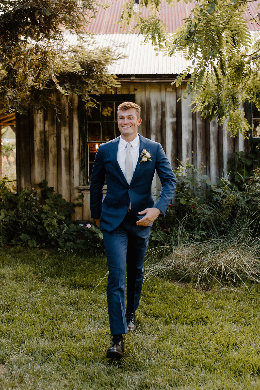 Stylish groom in slim navy suit 