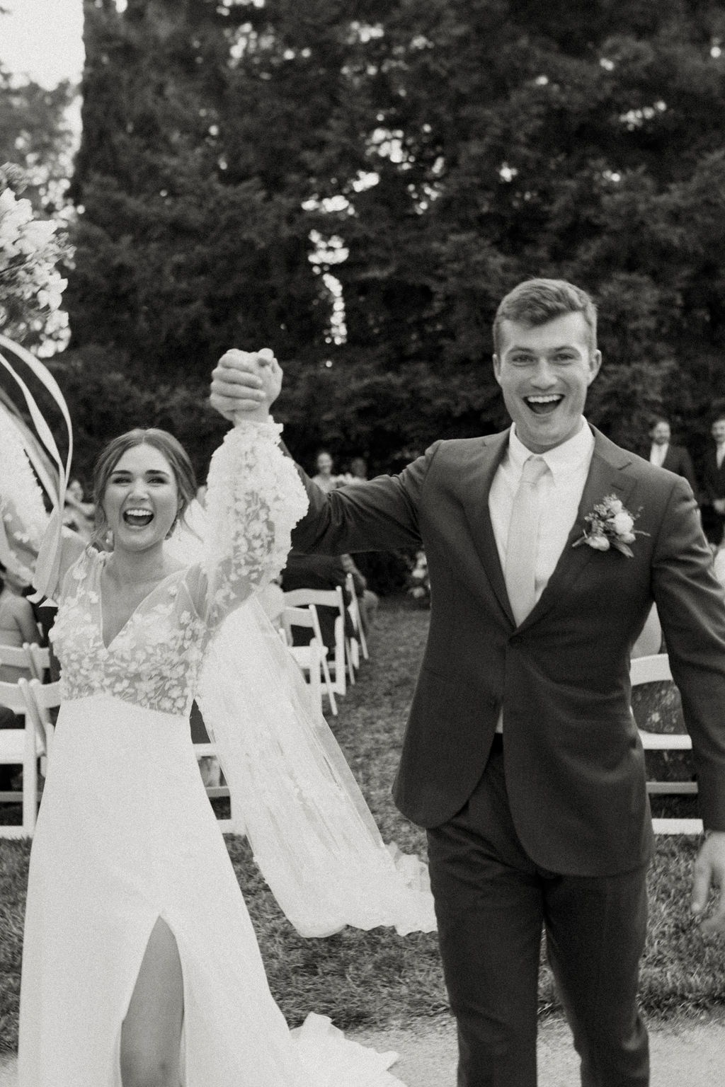 Boho bride and groom cheering after ceremony