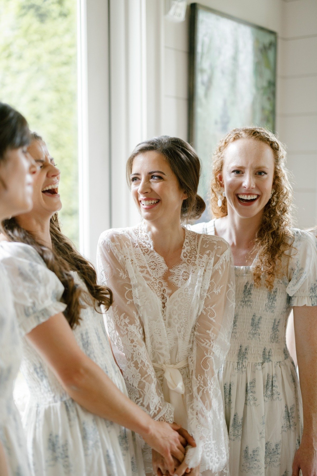 Bride in lace robe with bridesmaids 