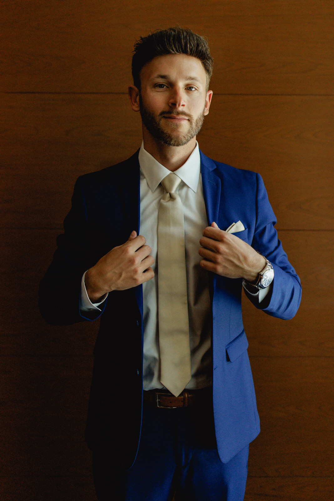 Groom in blue suit with champagne tie