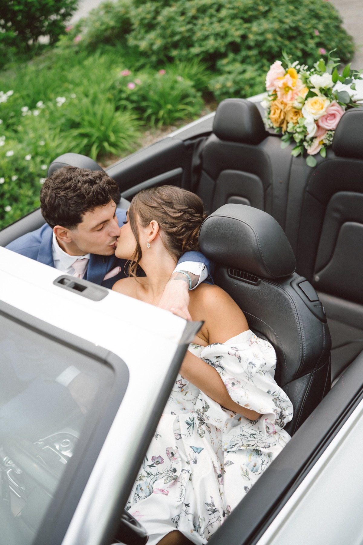 Couple kiss in getaway car