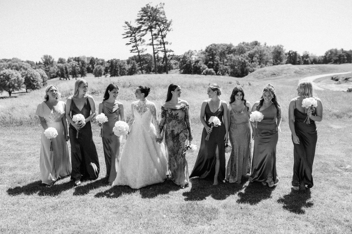 Mismatched bridal party gowns with lace bride 