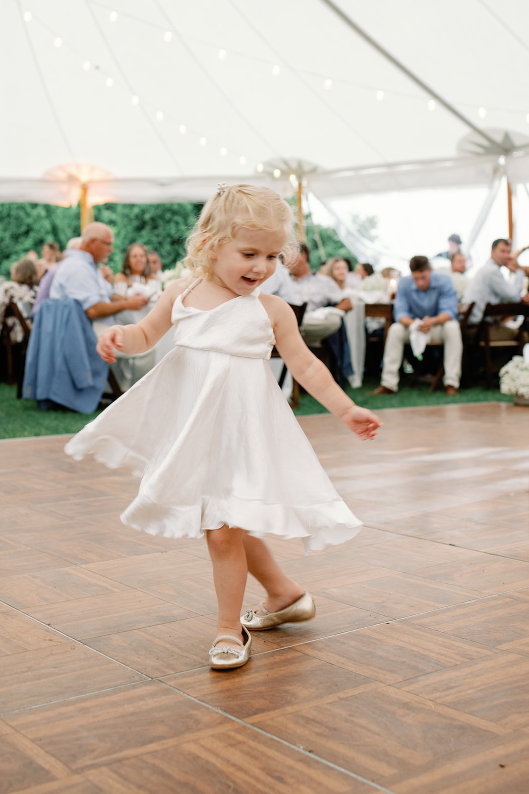Flower girl dancing at reception 