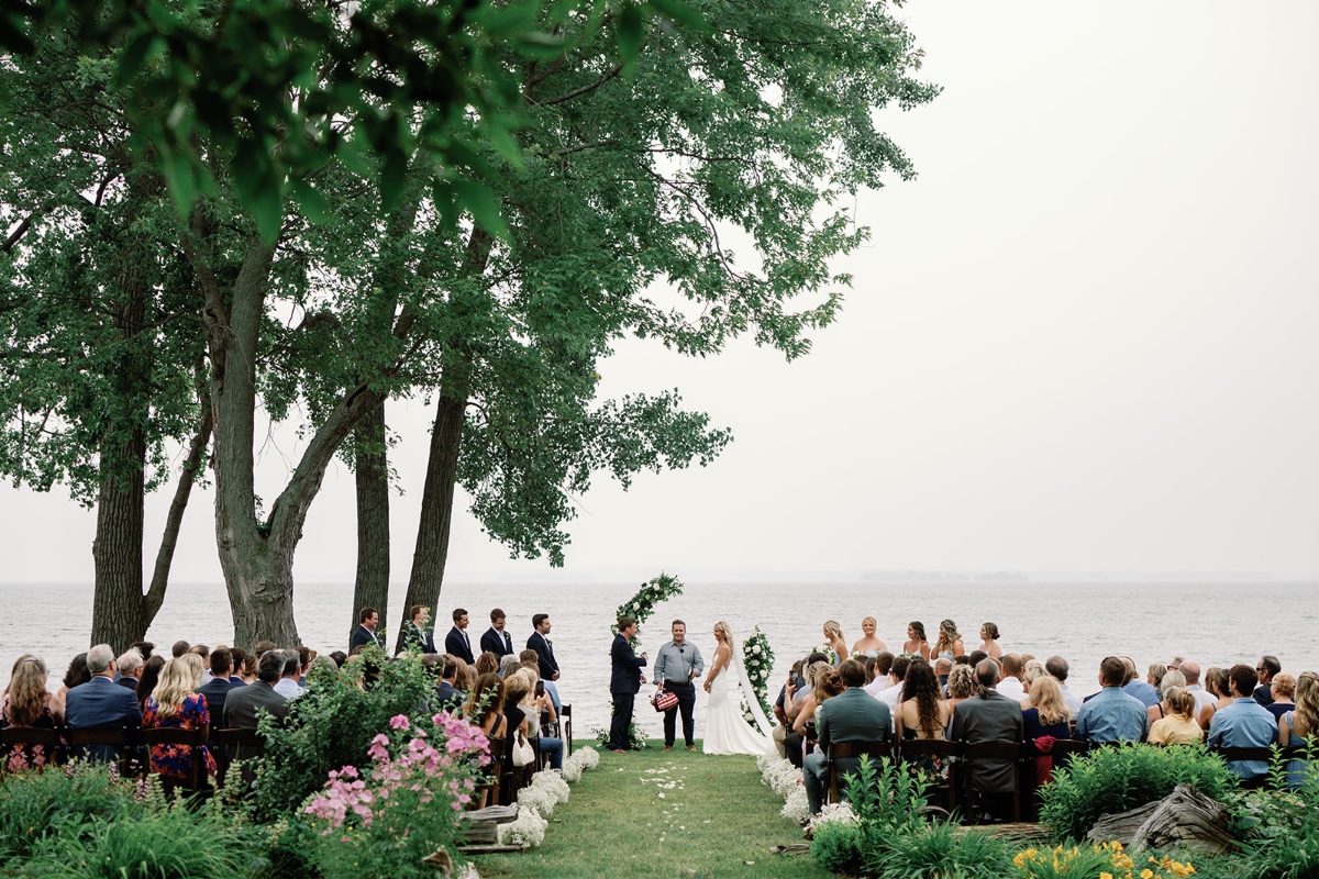 Lakefront white floral wedding ceremony