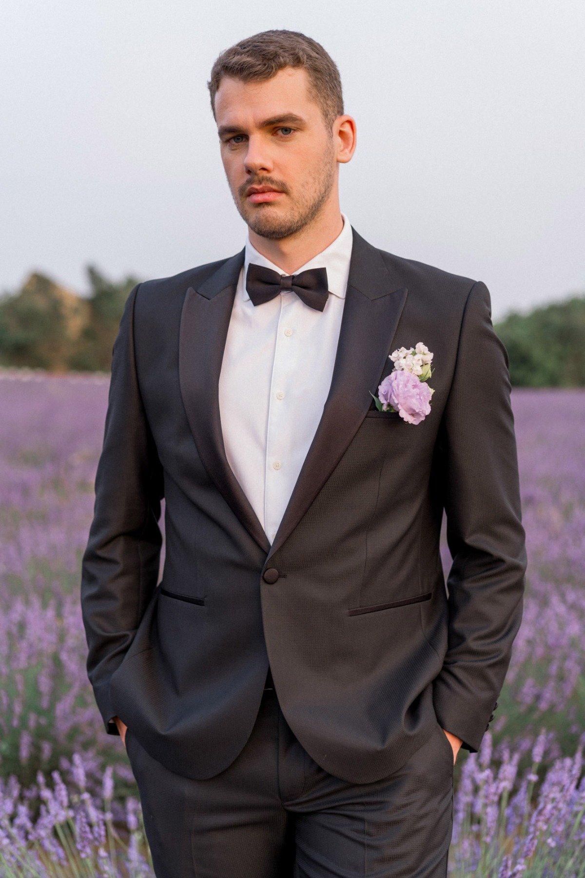 classic tuxedo with purple boutonniere 