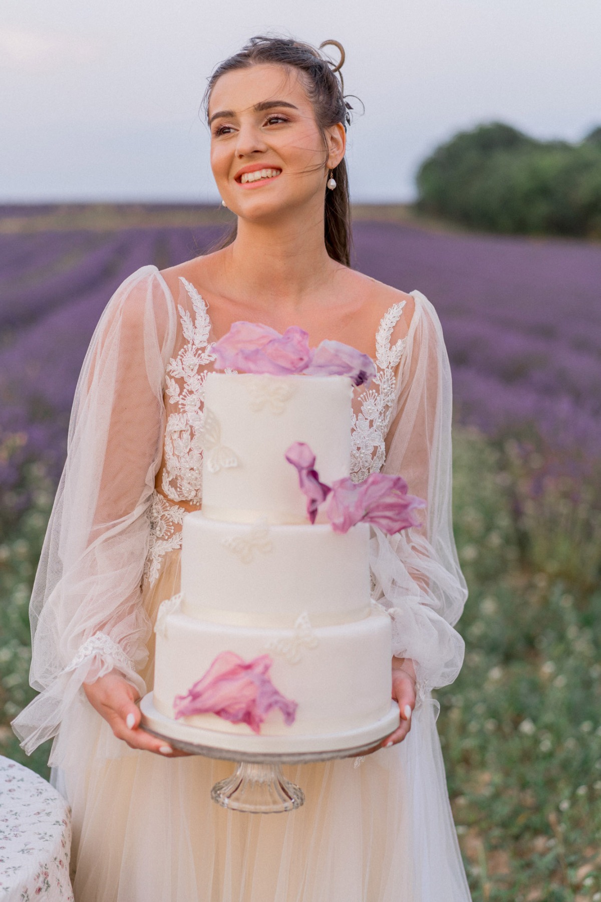Bride holding wedding cake 