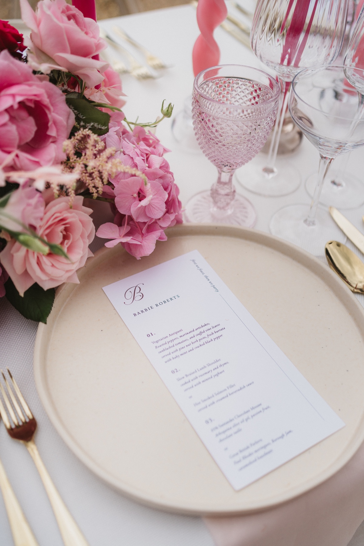 pink place settings with gold flatware