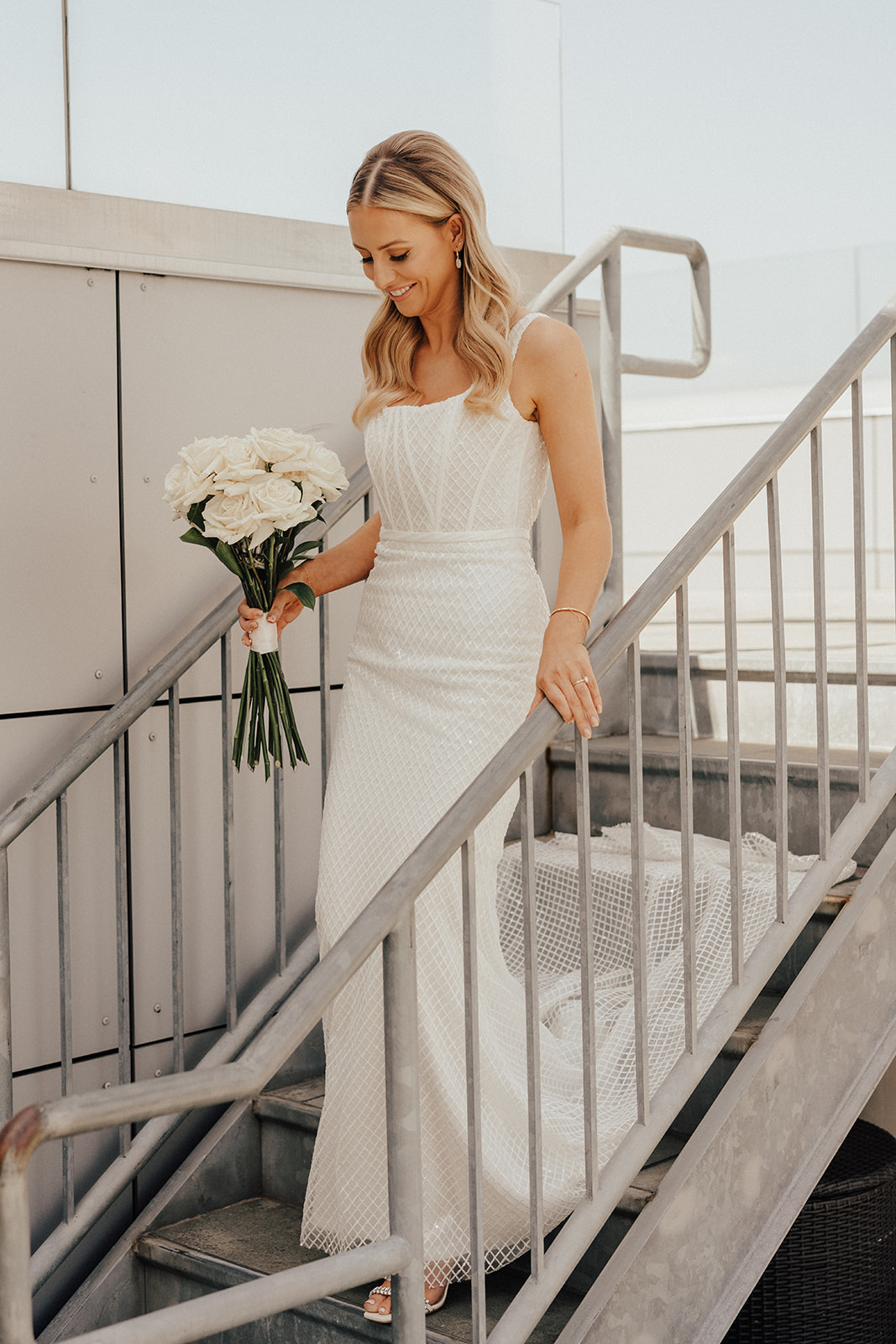 fishnet wedding dress and white rose wedding bouquet