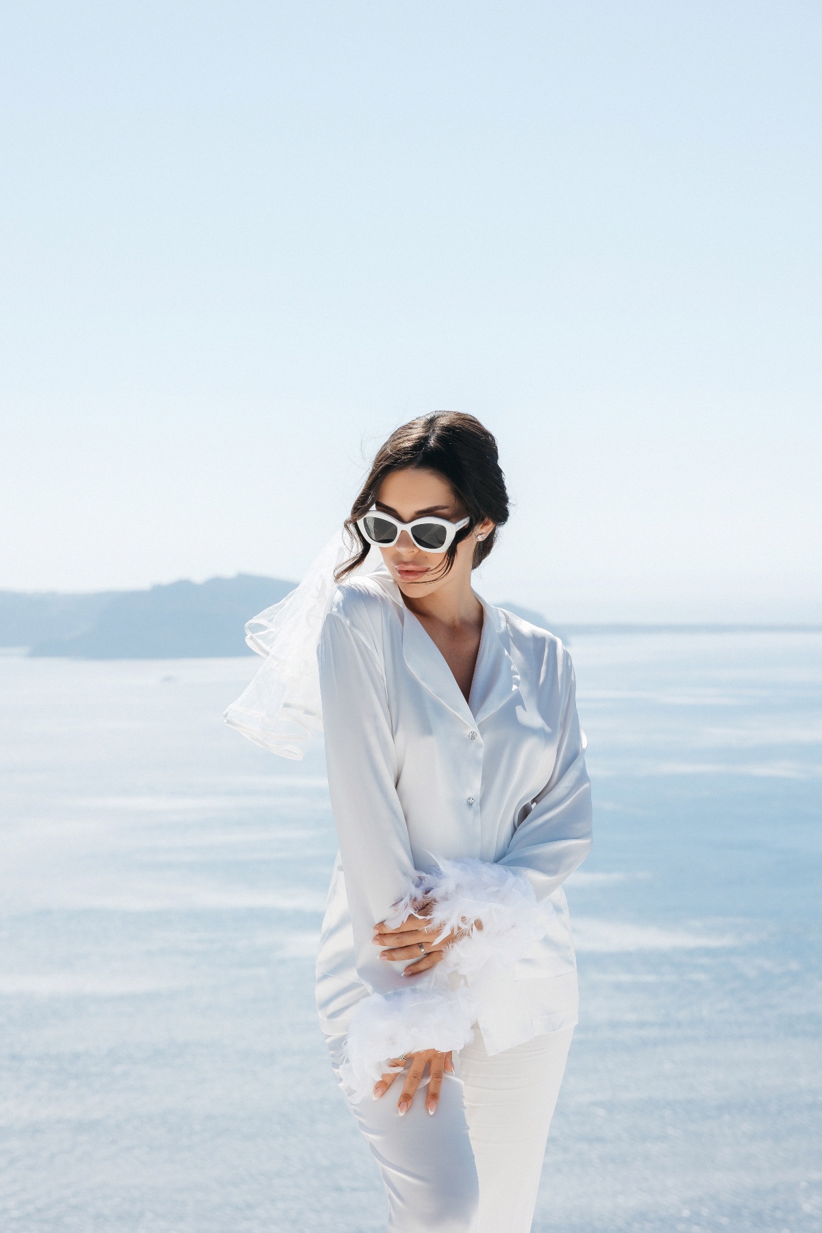 Chic Santorini bride in silk pajamas