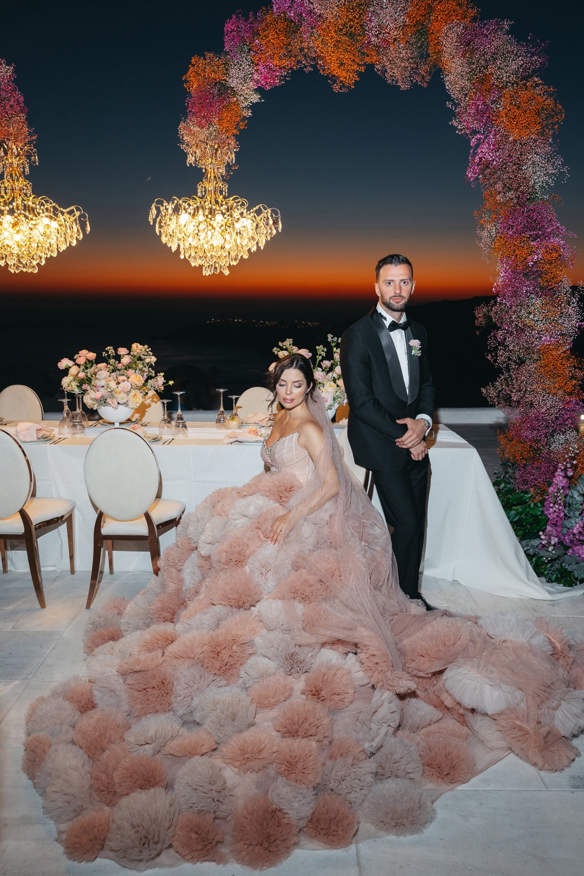Couture bride and groom at sunset reception 