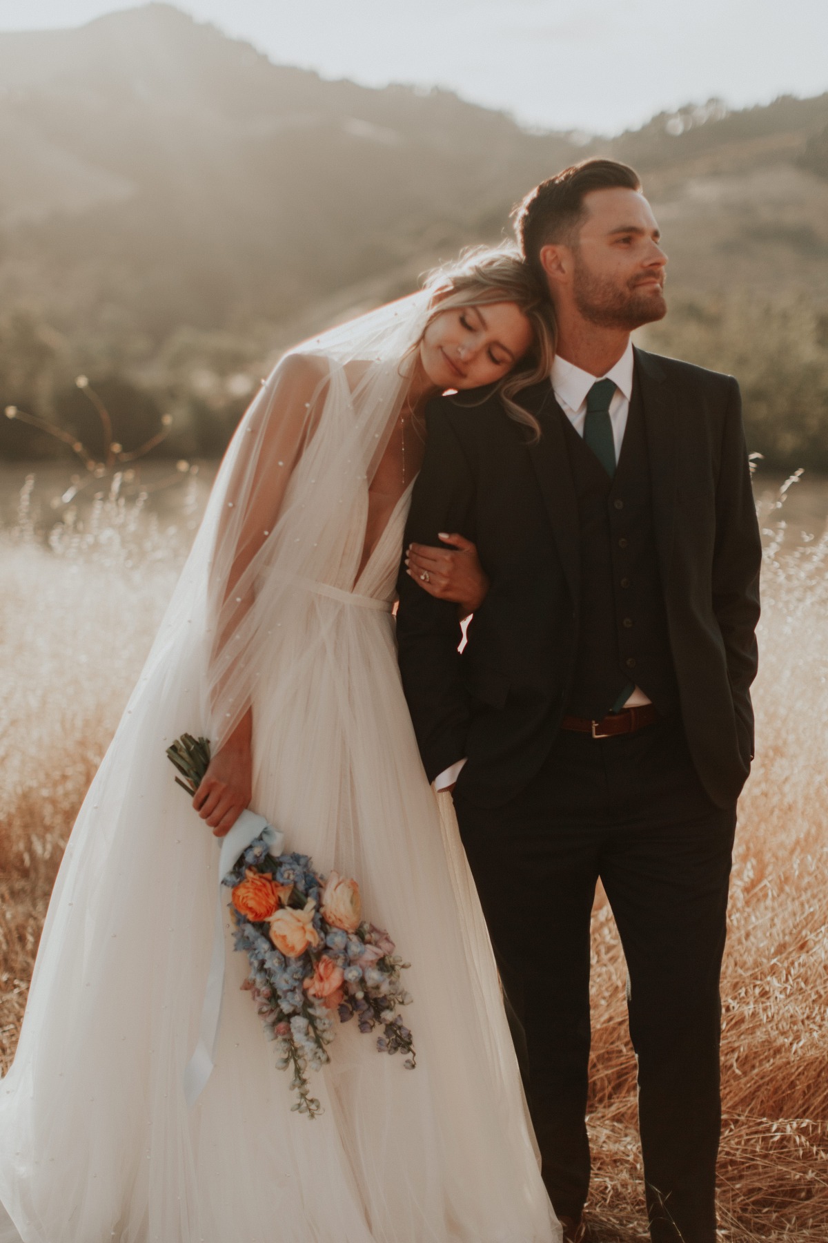 Romantic California newlyweds in field 