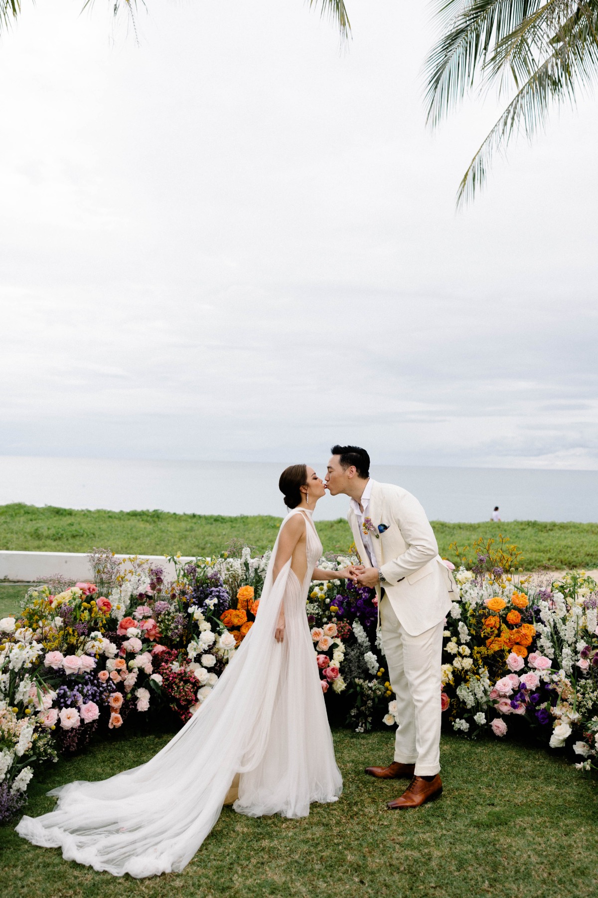 First kiss at vibrant floral ceremony