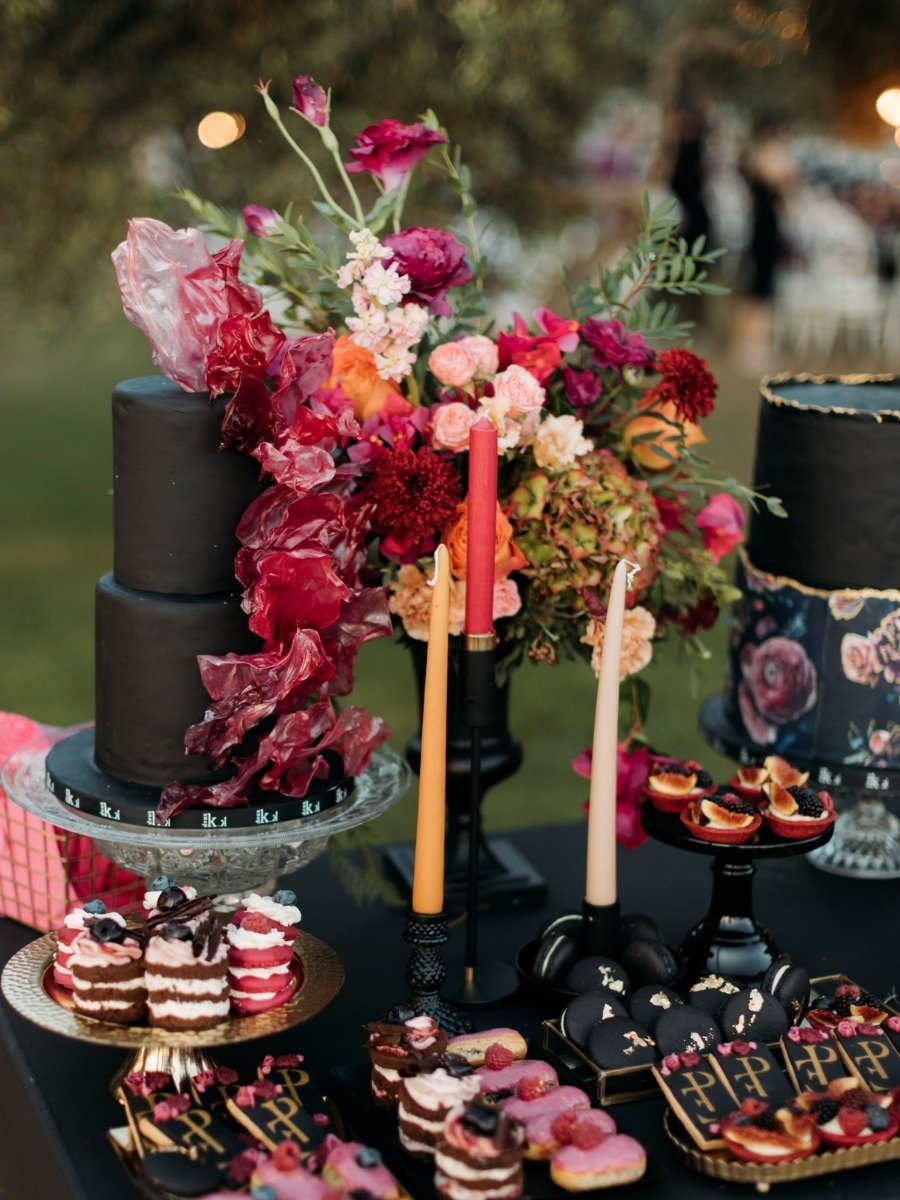 Bold black and magenta florals created a unique Greek beach wedding