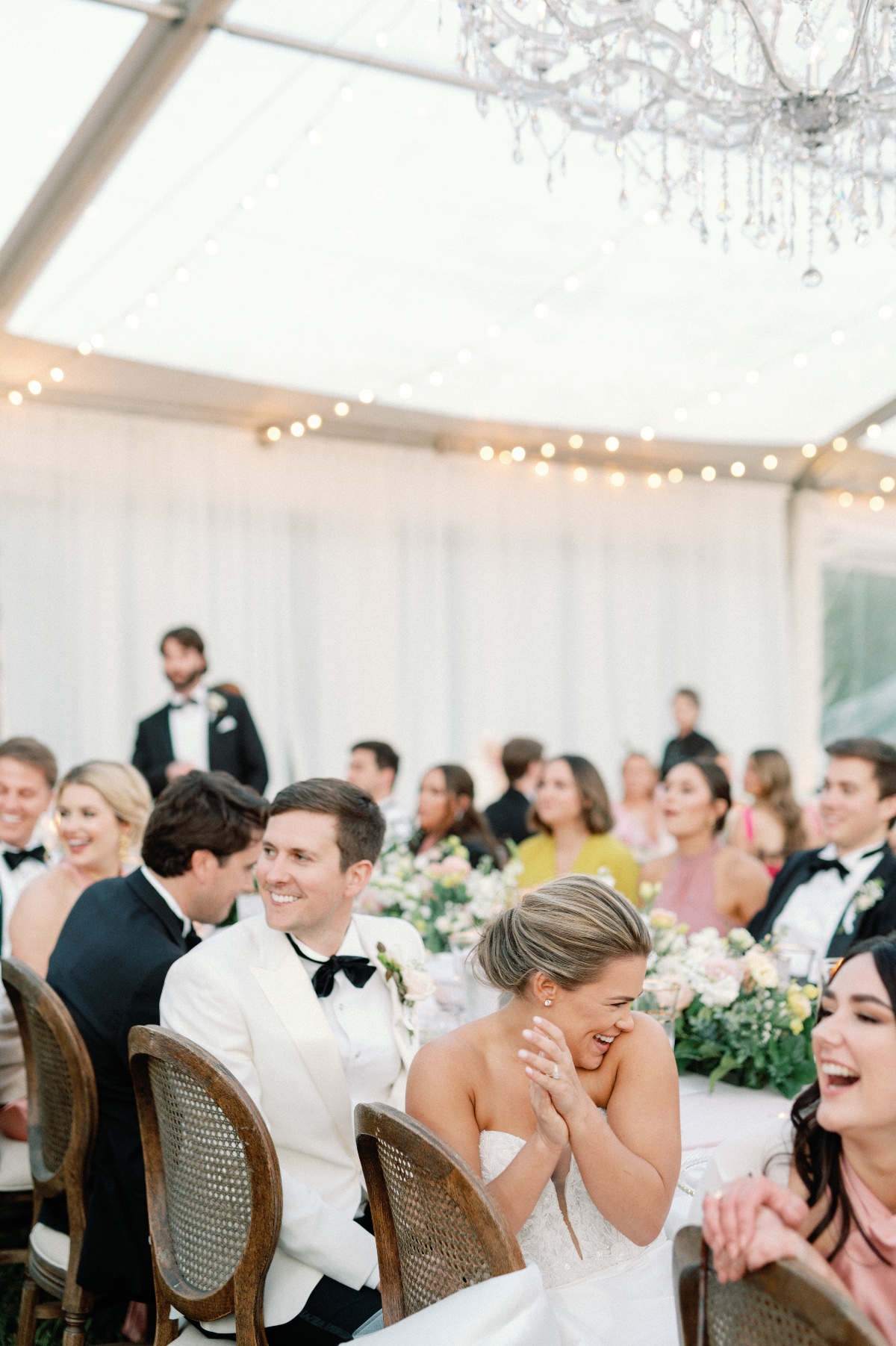 Newlyweds laughing at reception