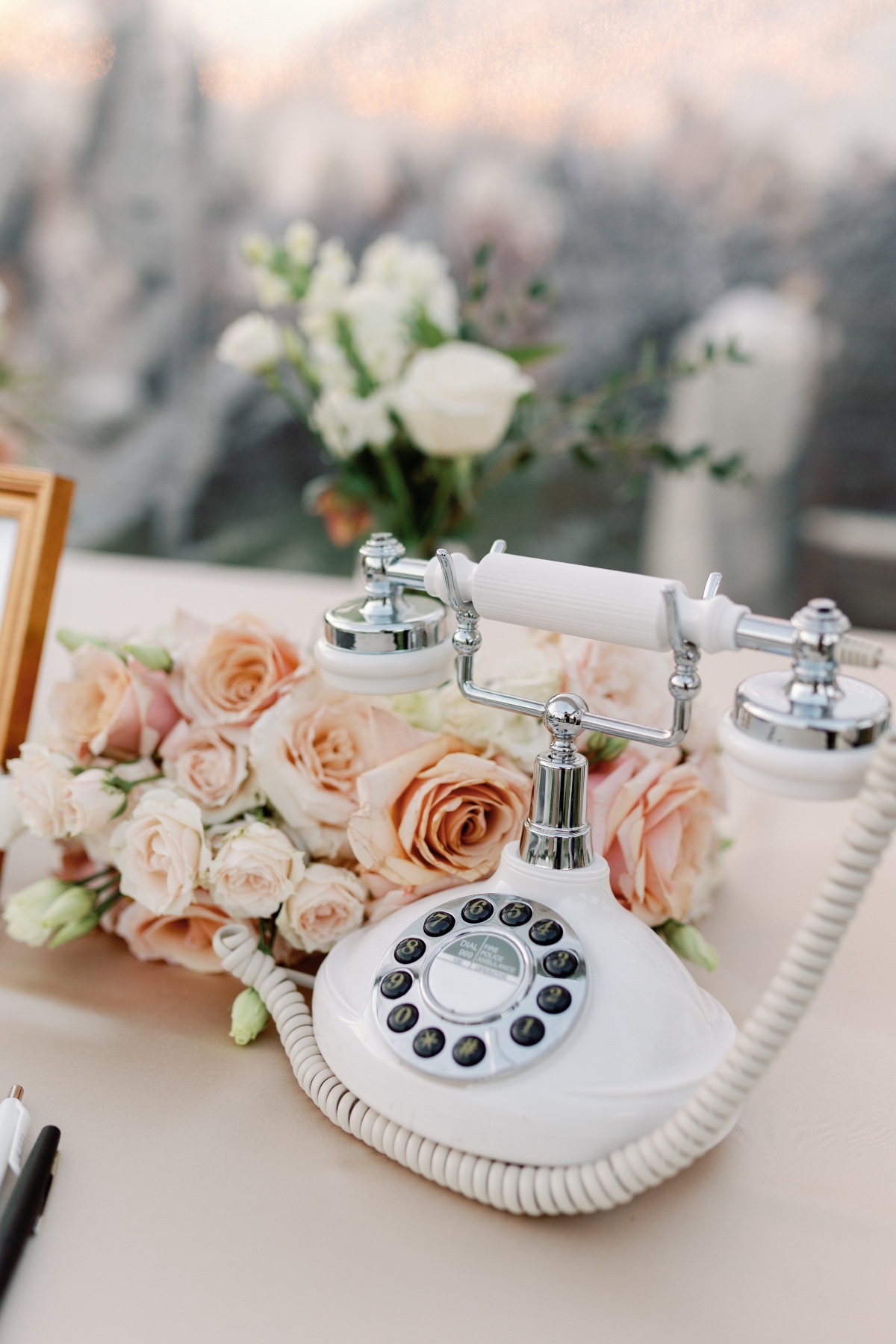 Pink guest book table with vintage phone