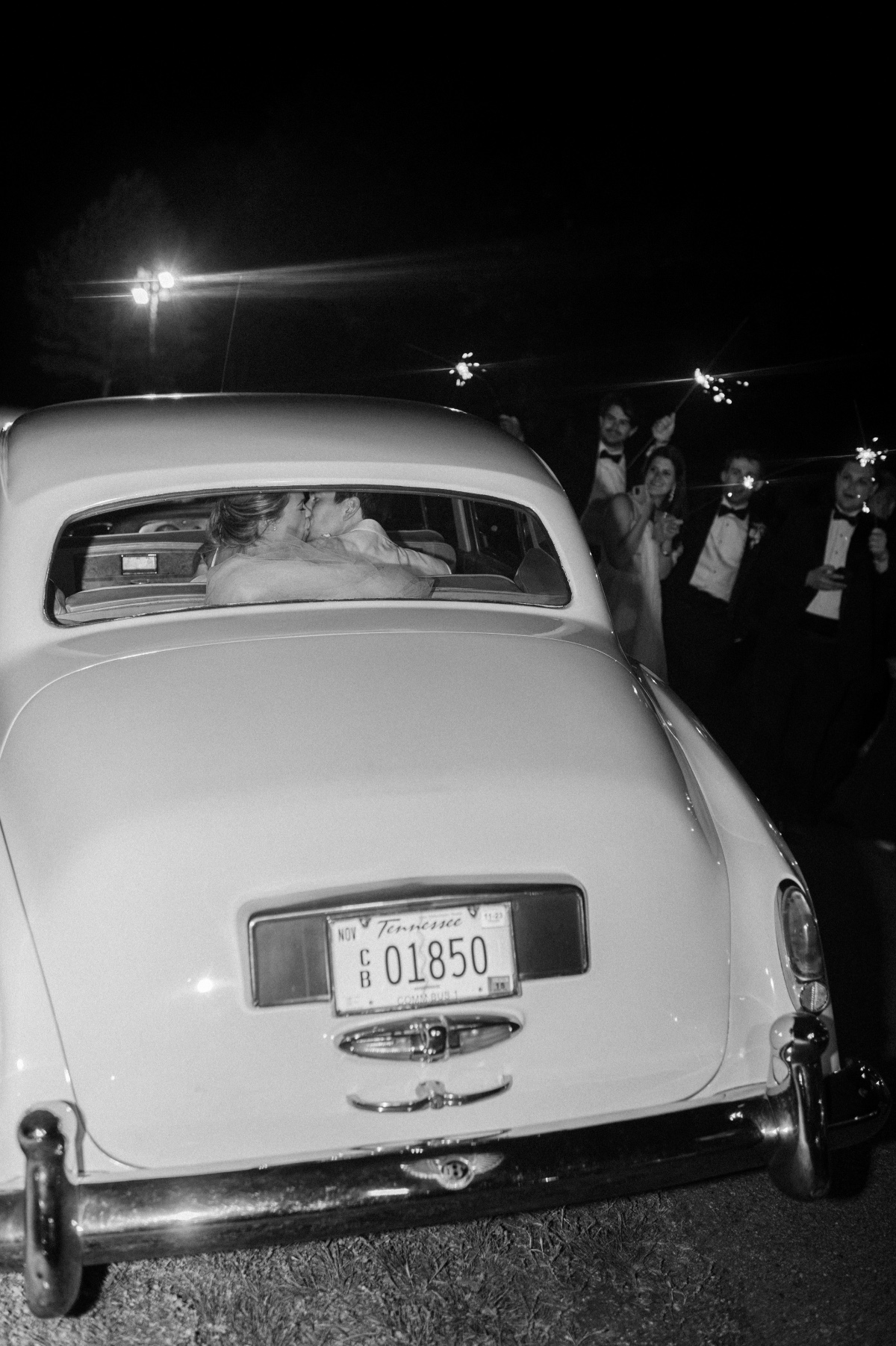 Vintage getaway car newlyweds