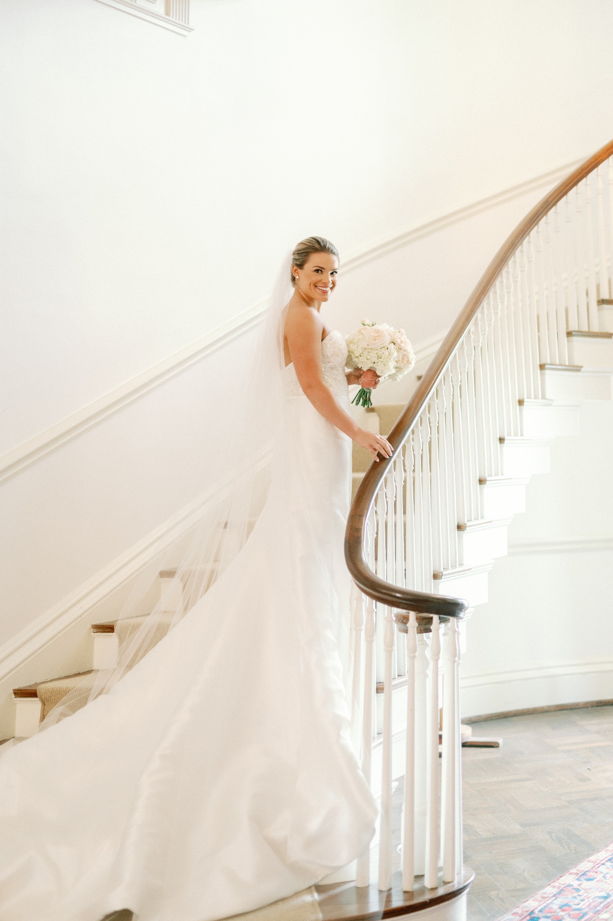 Elegant bride walking up stairwell