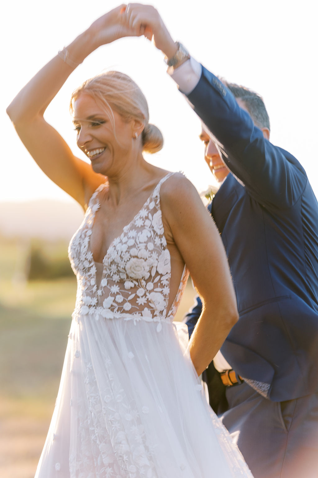 Bride and groom dancing at golden hour 