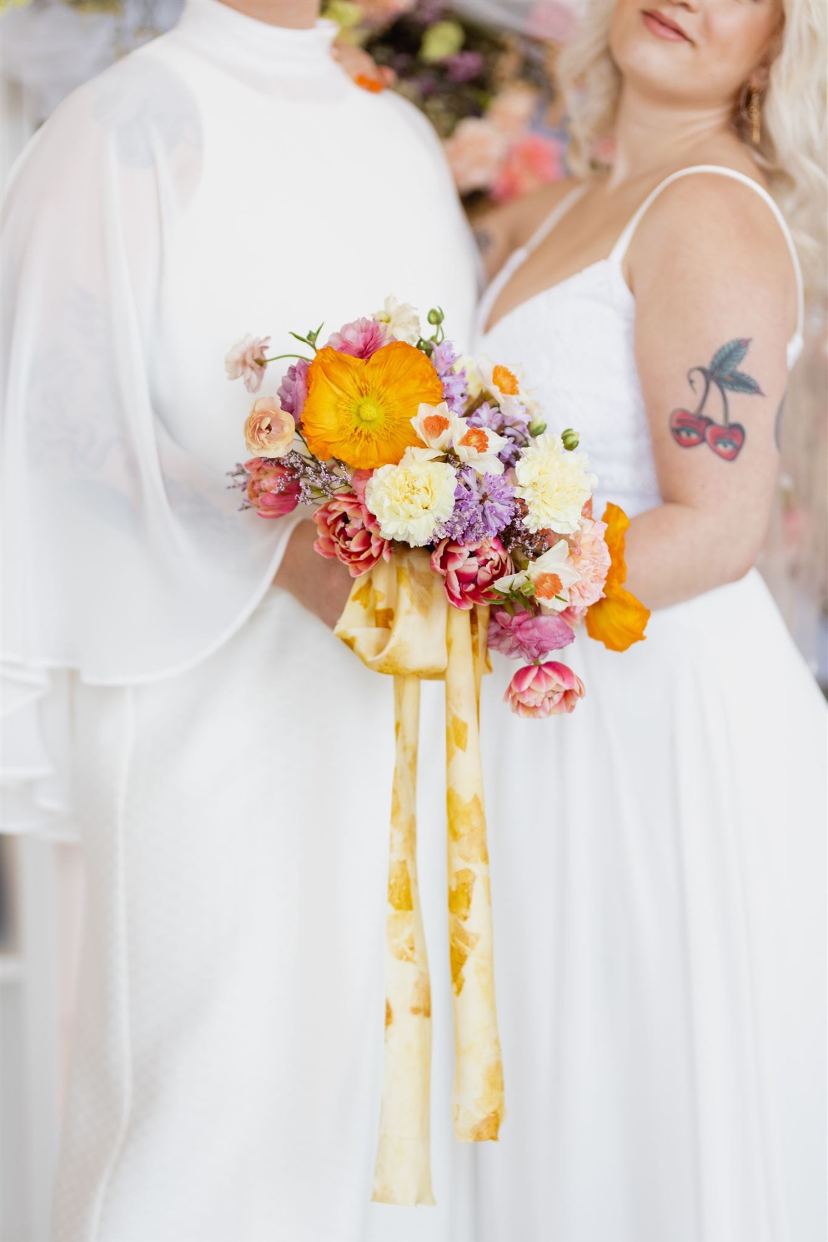 Queer couple holding bouquet