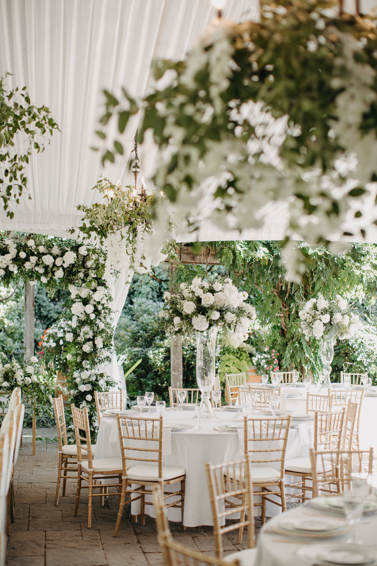 white centerpieces and floral chandeliers
