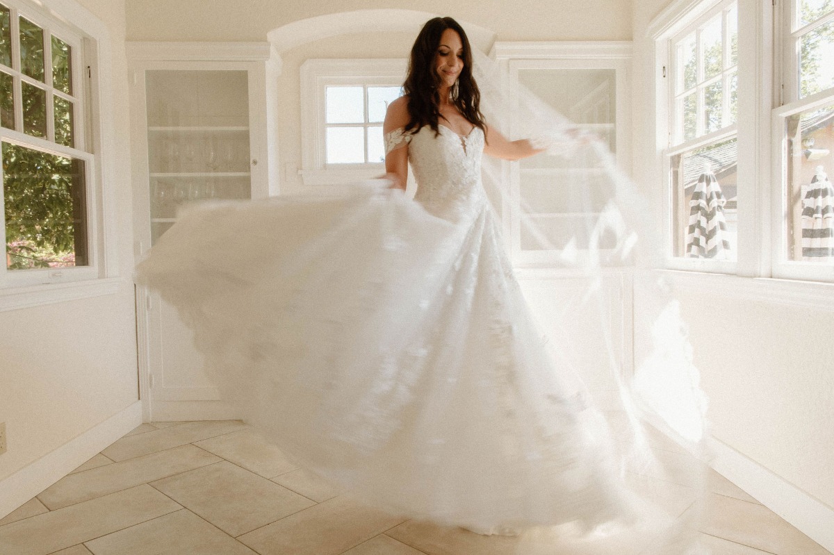 bride twirling in lace ballgown
