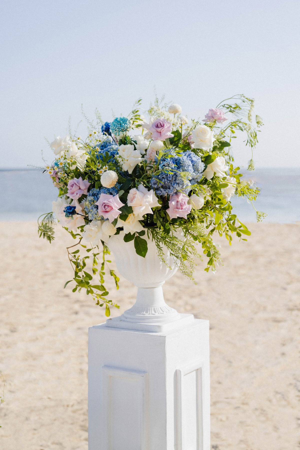 white flower arrangement pedestals