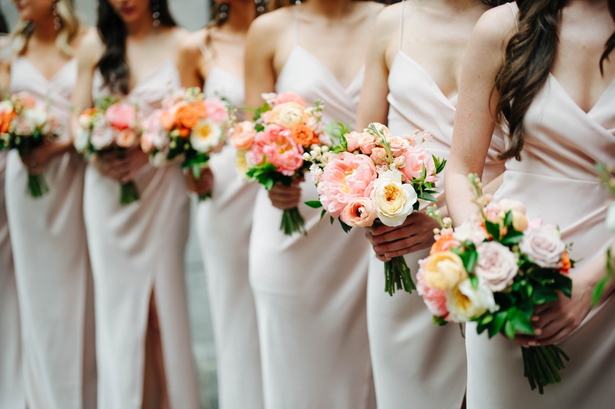 champagne bridesmaid dresses with orange and peach bouquets