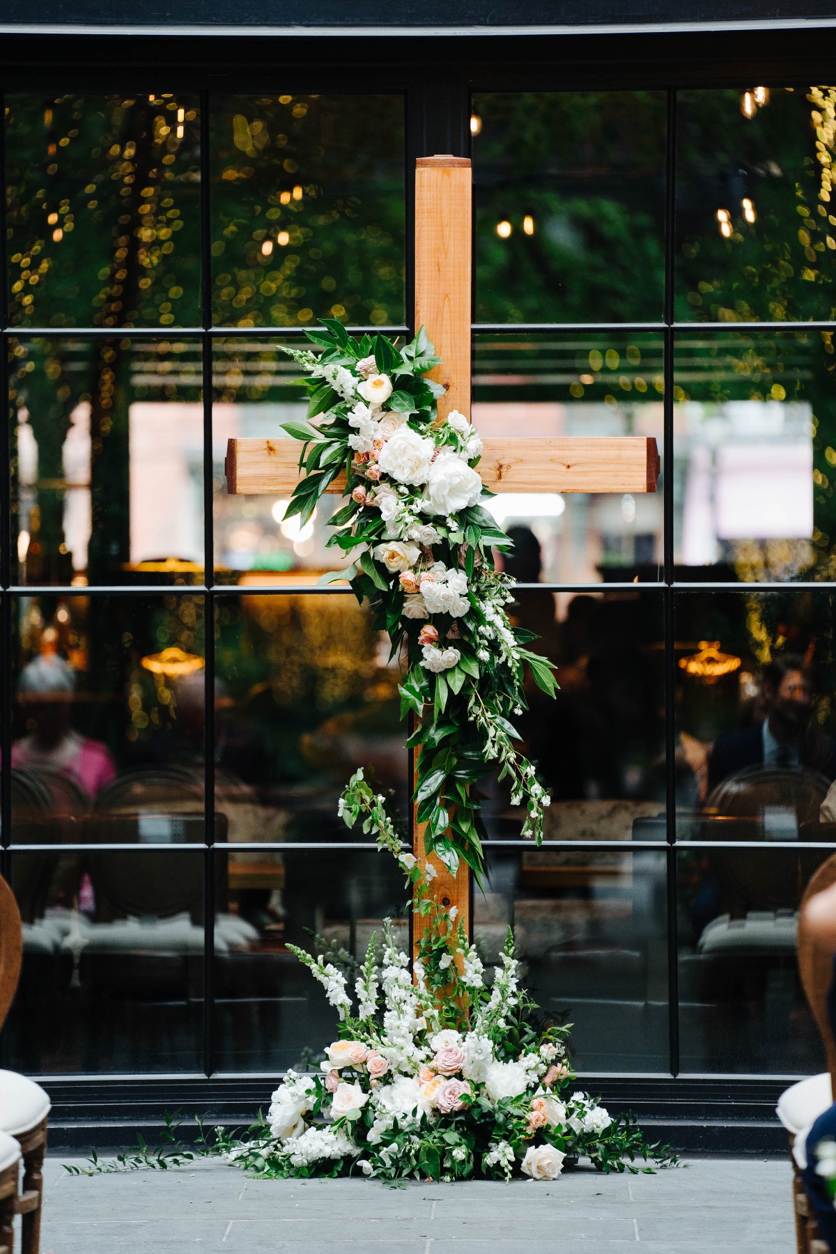 cross backdrop for wedding ceremony with flowers