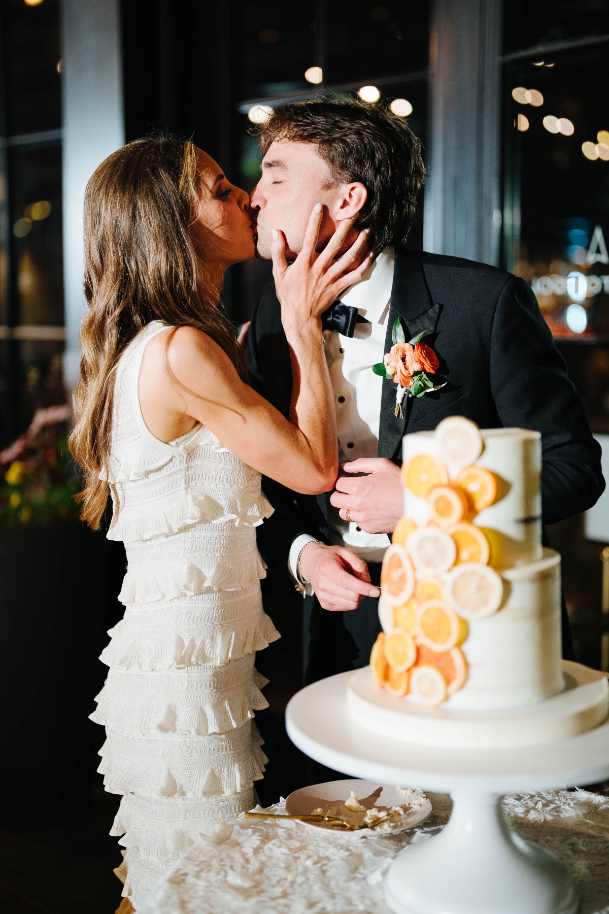 bride and groom cut a citrus cake