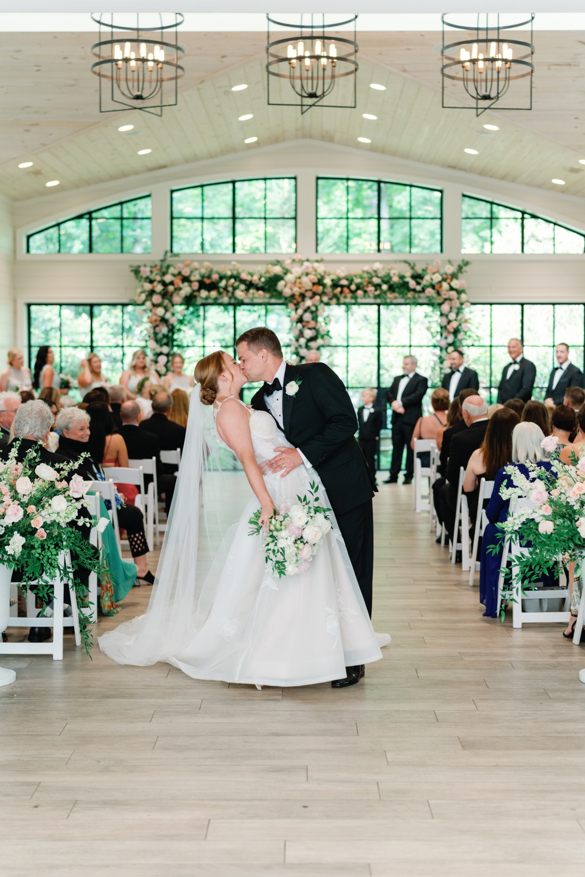 pastel wedding ceremony in whitewashed barn
