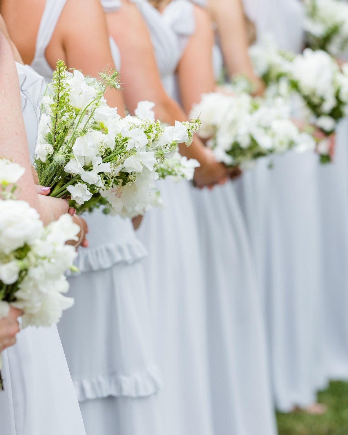 blue gray bridesmaid dresses with white bouquets