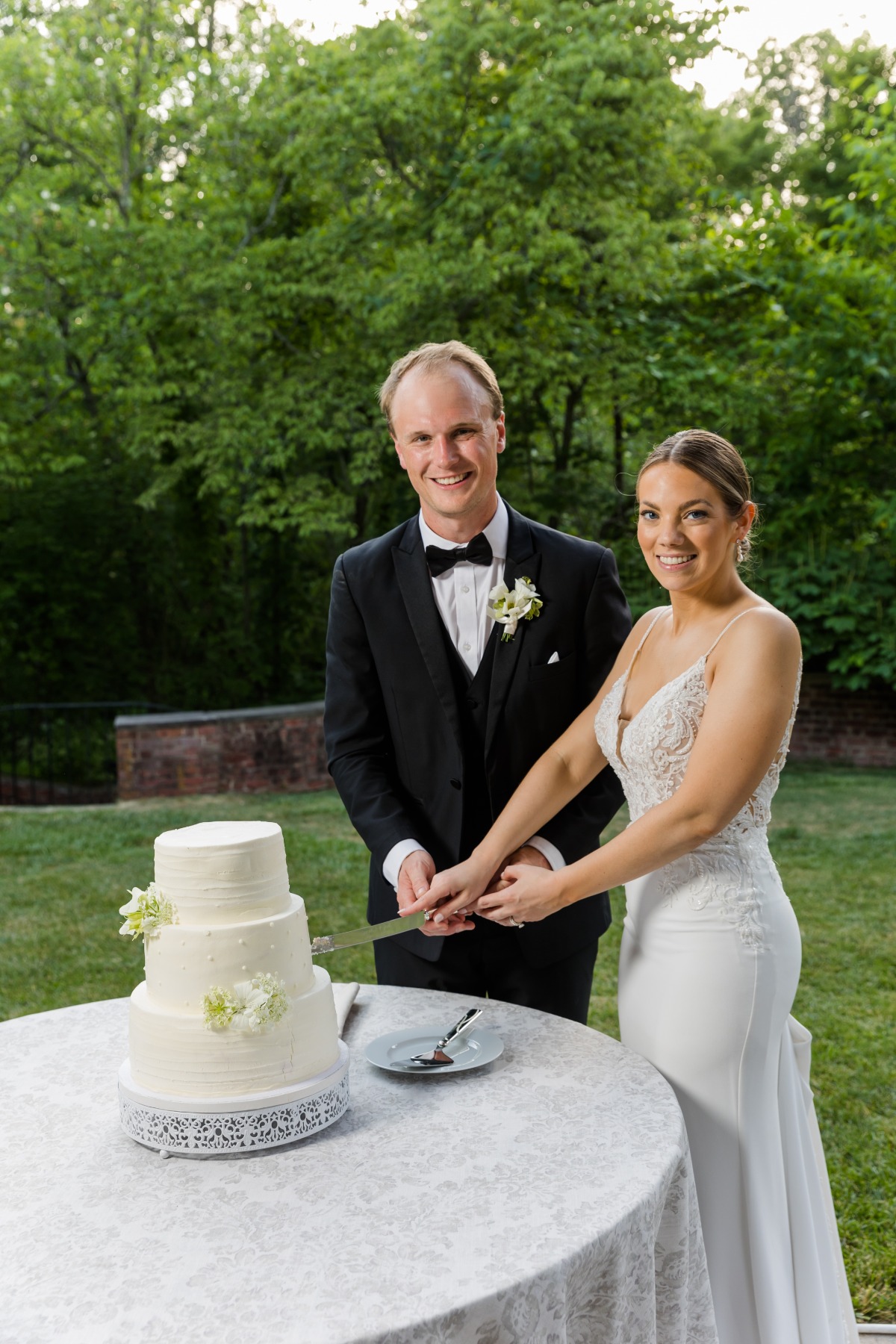 bride and groom cutting white buttercream cake