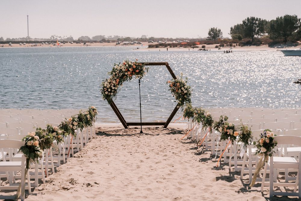 beach wedding at Mission Bay Resort with floral arch
