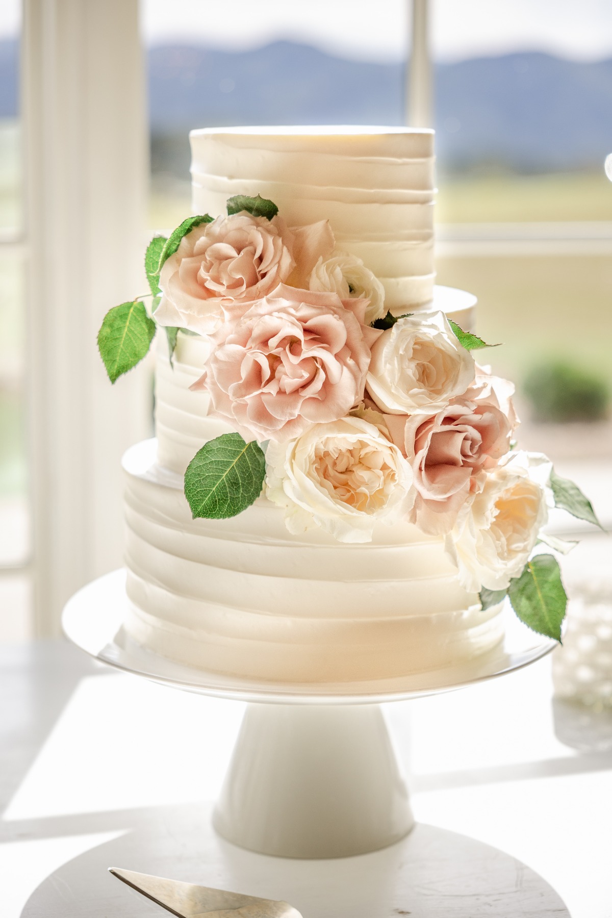 light pink wedding cake with roses