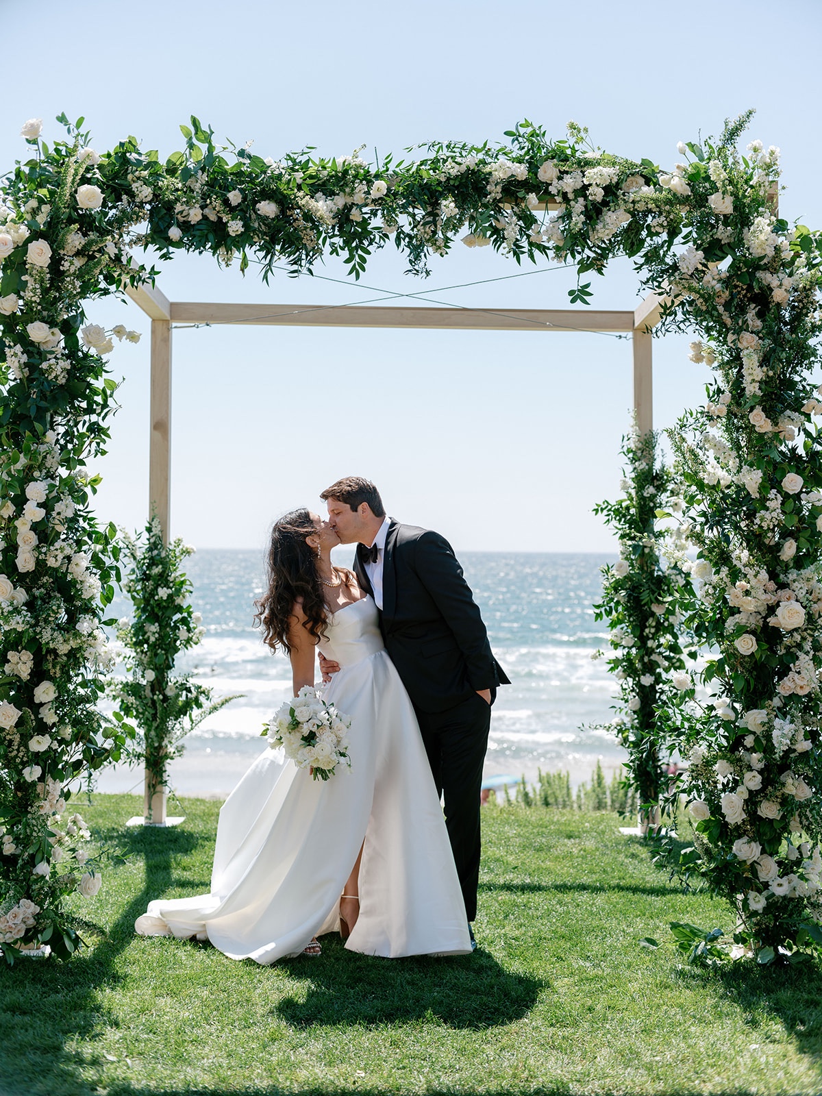 floral arch with white roses and greenery