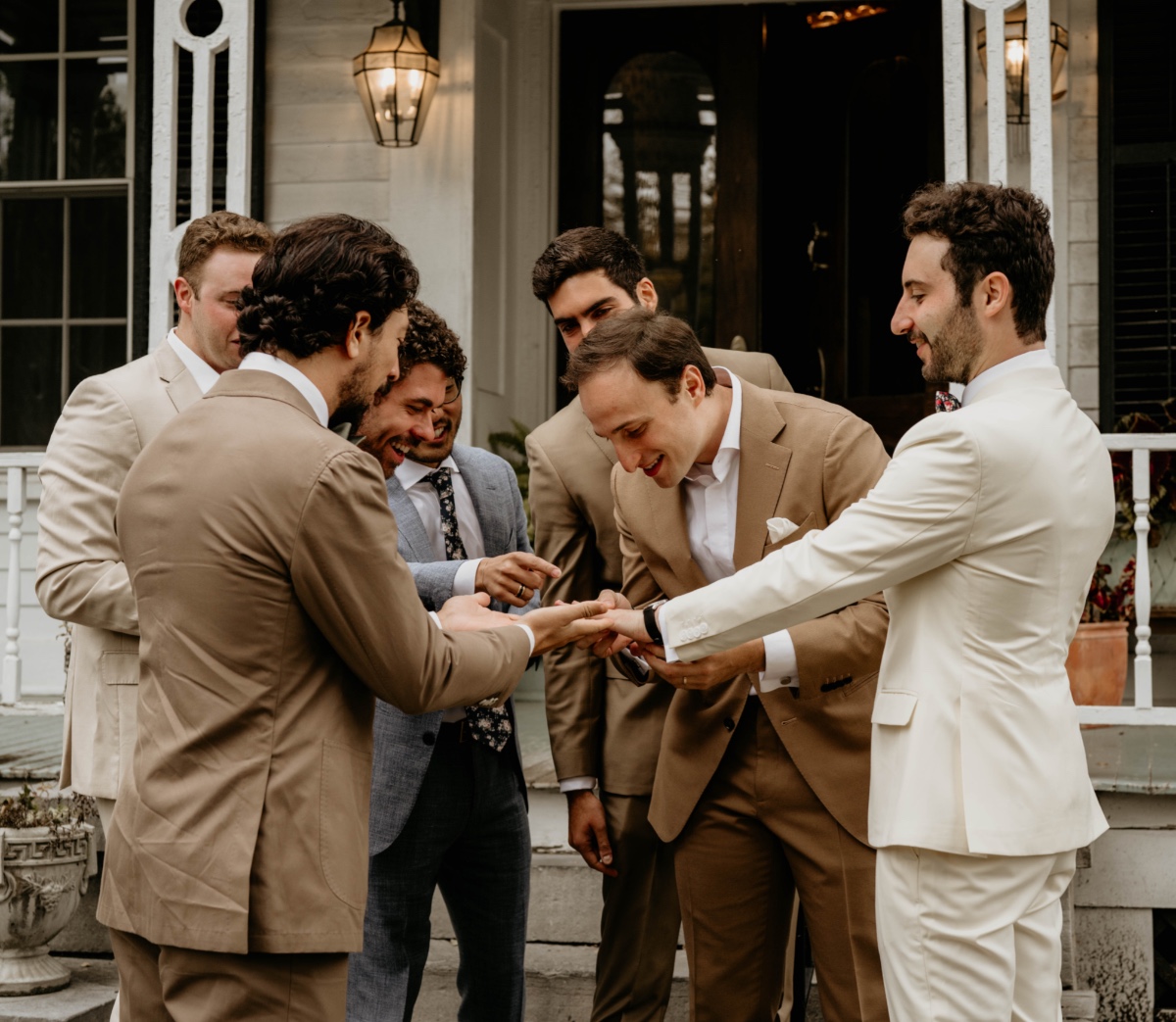 groom showing ring to groomsmen
